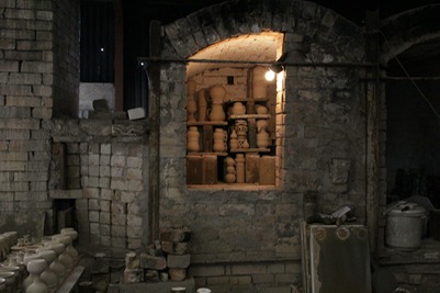 Half loaded bisque chamber in wood-fired kiln